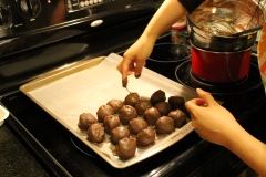 Put the chocolate covered cakeballs on a cookie sheet lined with parchment paper. (photo: Abby O'Connor)
